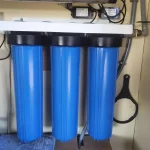 Triple water filtration system with three blue filter housings for clean water supply -Water Services NZ
