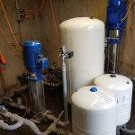 Water Services NZ pressure tank system with pumps and connected piping for rural water supply management.