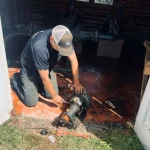 Water Services NZ technician repairing a water pump inside a rural pump station